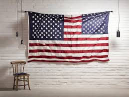 American Flag Hanging On White Brick Wall