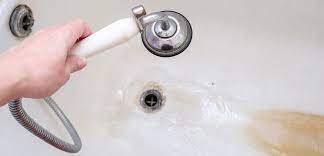 a shower drain with standing water