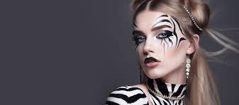 a woman with a zebra makeup on her face