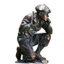bronze statue of palying golf boy