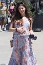 Pregnant Ashley Greene cradles her growing baby bump as she steps ...