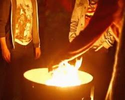 group of people dancing around a bonfire Diwali GIF
