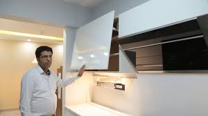 white handleless kitchen powered by