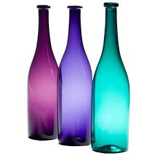 a group of coloured glass bottles