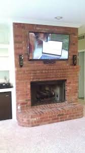 Tv Mounted Over Brick Fireplace With