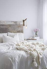 The bright hue sets a calming tone and provides a versatile base for layering in accent colors or in this airy bedroom, white covers the floors, walls, and ceiling, but a charcoal bed skirt and dark wood furniture help ground the decor. White On White Lindsay Marcella All White Bedroom Bedroom Inspirations Bedroom Design