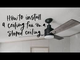 a ceiling fan on a sloped ceiling