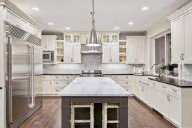 white kitchen cabinets with dark floors