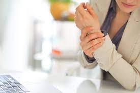 Closeup on business woman with wrist pain - TMIHI