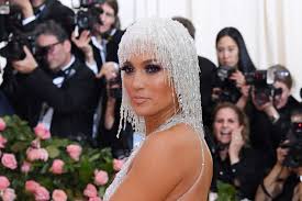 Sparkly red flame leotard with wild, curly hair. Met Gala 2019 Jennifer Lopez Hits Red Carpet In Iridescent Heels Footwear News