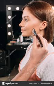 applying face foundation cosmetic brush