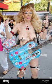 Sandy Kane The naked cowgirl poses with her guitar in Times Square where  she was performing for tips New York City, USA - 12.07.12 Stock Photo -  Alamy