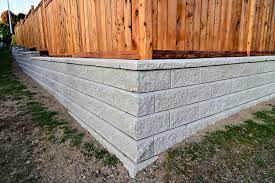 a fence on top of a retaining wall