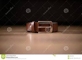 Brown New Leather Belt With Silver Buckle Positioned On A Light Brown Table With Dark Background Stock Photo Image Of Genuine Elegance 98629566