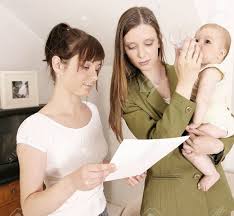 Working Mother Leaving A Baby At Home With A Babysitter Stock Photo