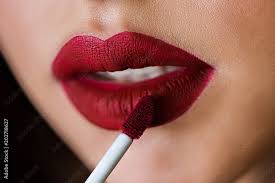 makeup artist apply lip gloss close