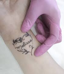 These tattoos usually are attached to names with the heart or even flowers or angel wings. Heart Design With Your Dear Name On The Wrist Tattoo Mode