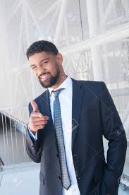 Positive Black Business Man Pointing At Viewer. Confident Guy Standing With  Building Constructions In Background. Business Man Portrait Concept. Front  View. Stock Photo, Picture And Royalty Free Image. Image 121992012.