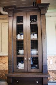 Chicken wire doors gives a farmhouse rustic vibe, and the large iron wheels are functional. Chicken Wire Hutch Houzz