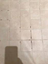 off white shower grout with black spots