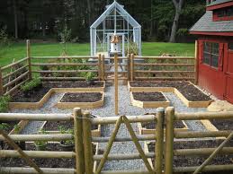 A Vegetable Garden With A Greenhouse