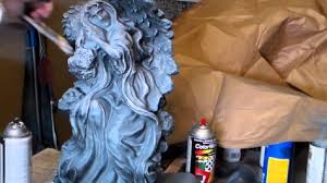 painting and detailing a cement statue