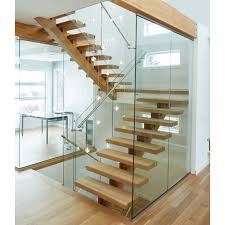 This is a view of the floating modern staircase with wooden steps and glass walls on its sides along with a large glass wall on the far side that brings in natural lighting. Modern U Shaped Staircase Single Beam Glass Railing Stainless Steel Handrail Design Living Room Sets Aliexpress