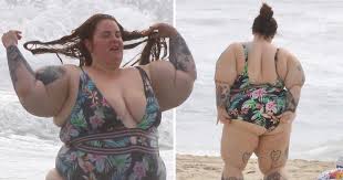 Tess Holliday Slays In Low Cut Swimsuit Amid Piers Morgan