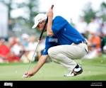 Fred Couples places his ball on the green at Fontainebleau golf ...