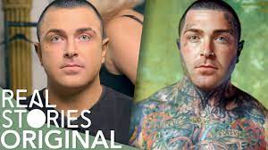 this heavily tattooed man wears make up
