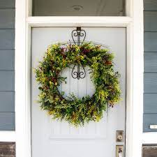 If you select one small enough and strategically arrange the branches or decor of your wreath. Brown Heavy Duty Cast Iron Metal Hangar Front Door Wreath Hanger Elegant Design Adjustable Hook Length For Tall And Small Doors Padding To Prevent Damage Like Scratch And Dents Home
