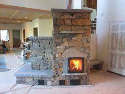 Masonry Heater With Stone Facing In