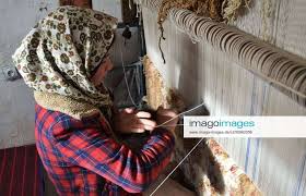 an afghan work at a carpet weaving