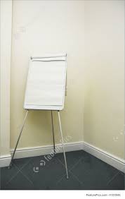 Artistic Tools Blank Flip Chart In Corner Of Plain Office Meeting Room