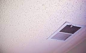 how to clean a popcorn ceiling the maids