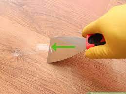 remove adhesive from a hardwood floor
