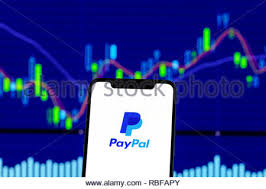Paypal Logo Is Seen On An Android Mobile Phone Over Stock