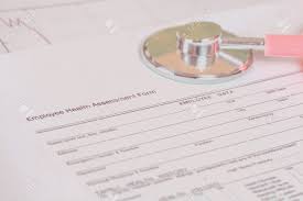 Close Up Employee Health Assessment Form And Stethoscope Stock Photo