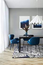 Navy blue and gold dining chairs surround a brown wood dining table placed beneath a chandelier finished with purple shades. How To Match A Dining Table With The Right Chairs Tlc Interiors