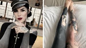 covering her tattoos with solid black ink