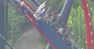 riders stuck on roller coaster in