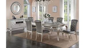 It has gray chairs and a lovely chandelier. Barzini Silver Finish Dining Room Table Set