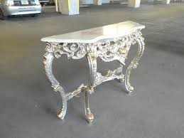 It features curved ends decorative onlays, rosettes, turned legs, and a silver leaf finish. 20th Century Italian Fab Heavily Carved Rococo Italian Silver Leaf Console Table Chairish Console Table Italian Silver Elegant Furniture