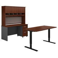 A credenza desk (often simply, credenza) is a modern desk form usually placed next to a wall as a secondary work surface to that of another desk, such as a pedestal desk, in a typical executive office. Bush Business Furniture Series C 60w Height Adjustable Standing Desk Credenza Hutch And Storage In Hansen Cherry Carrolls Office Furniture