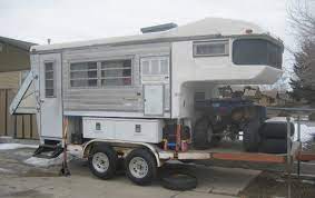slide in truck camper on flat trailer