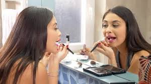beautiful woman putting makeup and