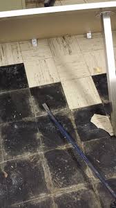 Wet Asbestos Floor Tile And Black Adhesive