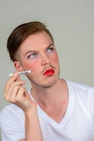 young man with beard stubble wearing makeup