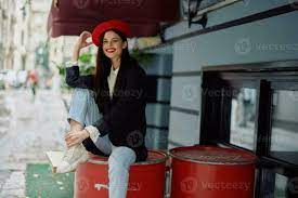 Cheerful woman smile with teeth sitting outside a cafe and bar on a city  street, stylish fashion look of clothes, vacation and travel. 25716187  Stock Photo at Vecteezy