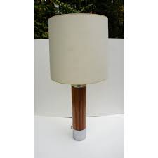The lamp has a fiberglass shade, a brass metal stem, standing on a metal chocolate brown round base. 1970s Mod Glam Lightolier Column Table Lamp Metronome Vintage